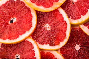 Close up of sliced grapefruit, background, red natural texture