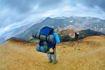 Wall Mural - hiker on the trail in the Islandic mountains. Trek in National Park Landmannalaugar, Iceland