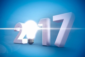 Composite image of 2017 with glowing light bulb over white backg