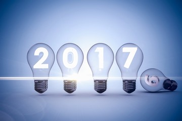 Poster - Composite image of light bulbs with 2017 over white background