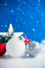 Wall Mural - red, silver and white christmas ornaments (balls, stars, spruce tree branch) on blue glitter backgro
