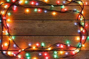 christmas lights border on wood background