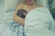 © LoloStock - Mother with newborn baby in hospital bed