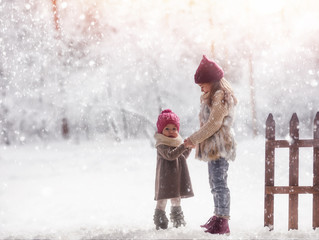 Wall Mural - girls playing on a winter walk