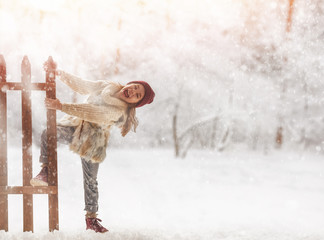 Wall Mural - girl playing on a winter walk