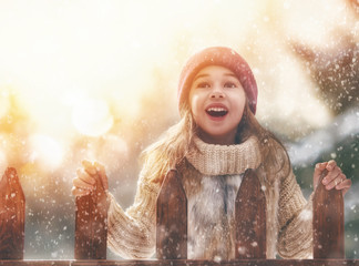 Wall Mural - girl playing on a winter walk