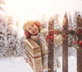 Wall Mural - girl with Christmas gift on a winter walk