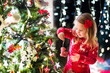 © famveldman - Child decorating Christmas tree