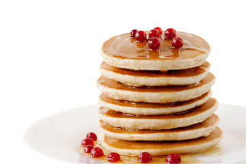 Wall Mural - Pancakes with maple syrup and cranberries isolated on a white background. Breakfast, snacks.