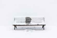 Snow-covered Wooden Bench With An Imprint Of Someone, Who Had Been Sitting In The Middle; Winter Has Gone