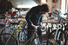 Mechanic Examining A Bicycle Handle Bar