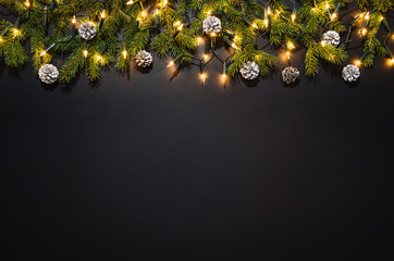christmas decoration background over black chalkboard, top view. horizontal photo of decorations tak