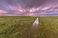 Sunset Over Ditch In Tidal Marsh
