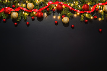 christmas decoration background over black chalkboard, top view. horizontal photo of decorations tak
