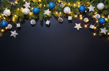 christmas decoration background over black chalkboard, top view. horizontal photo of decorations tak