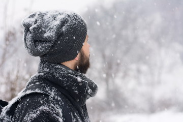 man standing in a park while snows