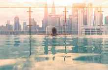 Kuala Lumpur, Malaysia City Skyline At Sunrise. Swimming Pool On Roof Top With Beautiful City View Kuala Lumpur Malaysia.