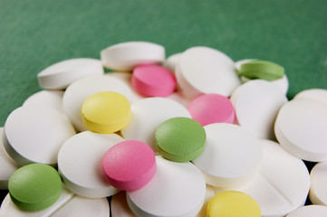 Wall Mural - Pills and tablets on a green background