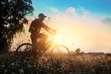 Biker on mountain bike adventure in beautiful flowers nature of rural