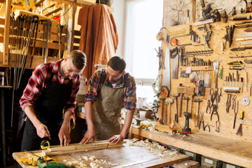 Wall Mural - carpenters with ruler and wood plank at workshop