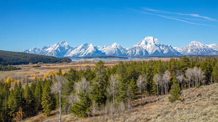 Beautiful snow-capped mountains. Golden autumn. Grand Teton National Park, Wyoming, USA