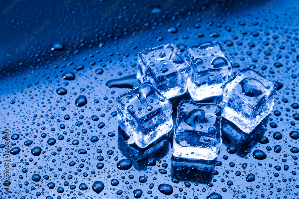 Wet ice cubes and water drop on blue background. Stock Photo | Adobe Stock