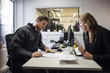 © Maskot - Owner and customer discussing over documents in auto repair shop
