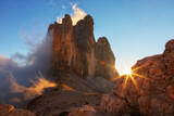 Fototapeta Na sufit - Fog, lit by the sun at sunset among the rocks the Cime di Lavaredo the Tre, Dolomites, Italy