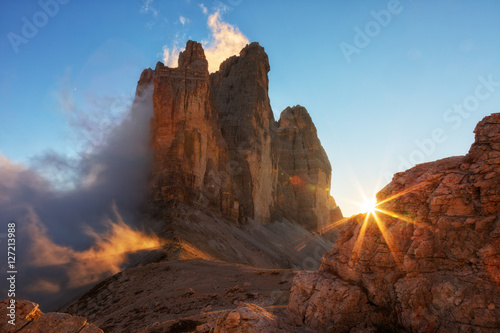 Fotografie, Tablou Fog, lit by the sun at sunset among the rocks the Cime di Lavaredo the Tre, Dolo