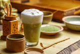 Fototapeta Kwiaty - Matcha tea latte in glass