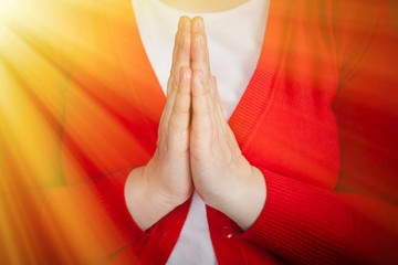 two hands in prayer position praying to God