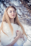 Fototapeta Do akwarium - beautiful fabulous blonde girl in the snow
