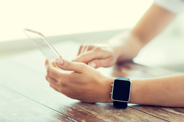 Canvas Print - close up of hands with smart phone and watch