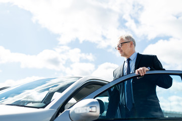 Canvas Print - senior businessman getting into car