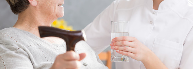 Wall Mural - Glass of water for elderly woman