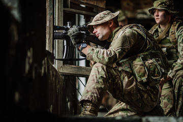 Soldiers on patrol in destroyed city. Military and rescue operation