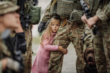 Soldier and children on battlefield background.