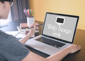 Wall Mural - business hand typing on a laptop keyboard with web design homepage on the computer screen website ho