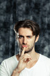 © fotofabrika - Young man with finger on lips asking for silence