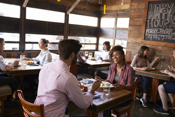 Mixed race couple enjoying lunch in a busy restaurant