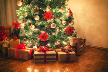 christmas gifts in front of christmas tree