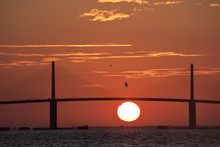 Sunrise Behind The Sunshine Skyway Bridge Linking Tampa St. Petersburg, Fl To Sarasota Across Tampa Bay.