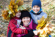 © lozochka - Mother and children in autumn park