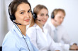 © rogerphoto - Call center. Focus on beautiful woman in headset