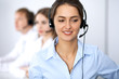 © rogerphoto - Call center. Focus on beautiful woman in headset