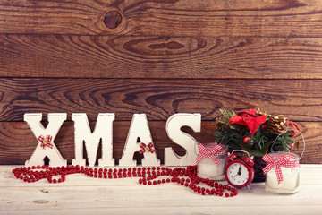 Wall Mural - Christmas decorations. Christmas background. Watch, candle and Christmas text on wooden table.