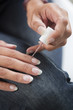 © Tjeerd - image of a woman applying nail polish on her nail carefully.