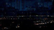 Stream Of Cars Lighting Up City Roads At Night
