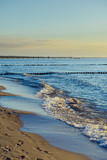 Fototapeta Fototapety z widokami - Breakwaters in the Baltic sea over the sunset