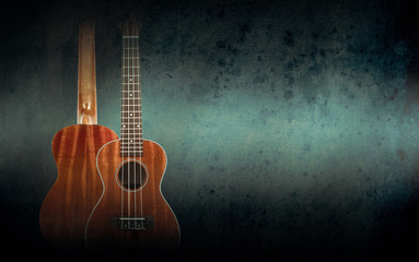 Part of a orange acoustic guitar on black background.